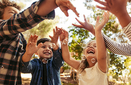 Children playing with bubbles