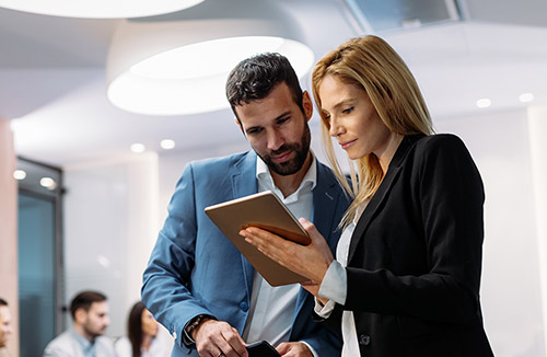 Colleagues viewing tablet